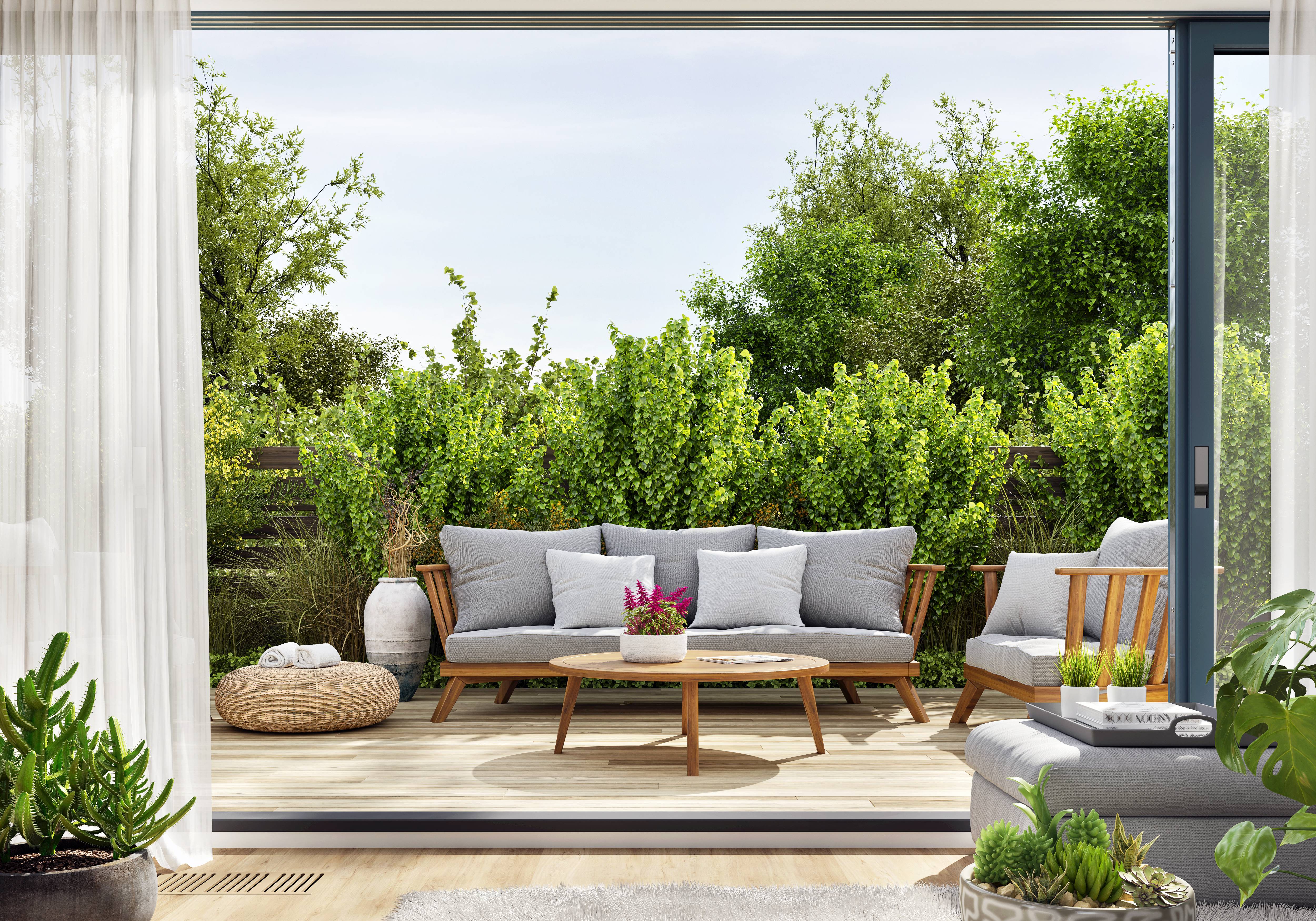 Wooden outdoor furniture in a lush garden.