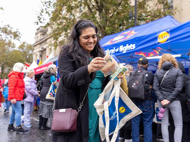 Woman with Lidl bags at a festival.