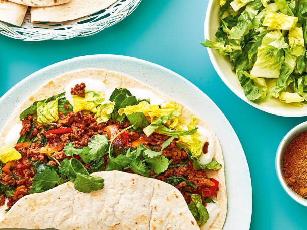 Tortillas with minced meat, yogurt, and salad.