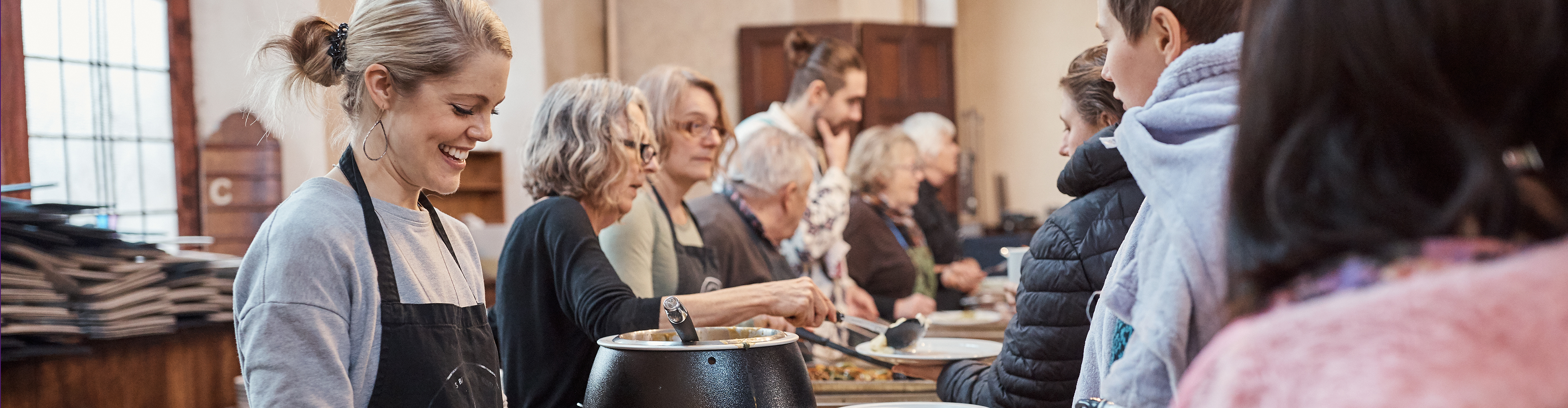 Food being served in a community dining hall.