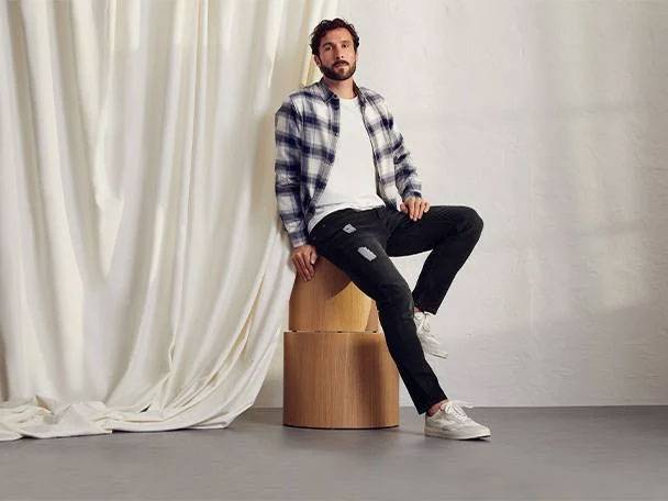Jeans and plaid shirt.