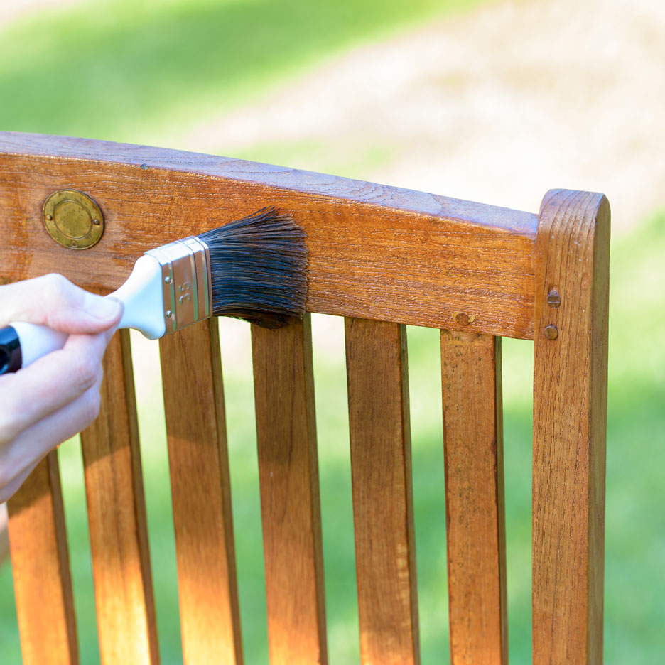 Painting a wooden garden chair.