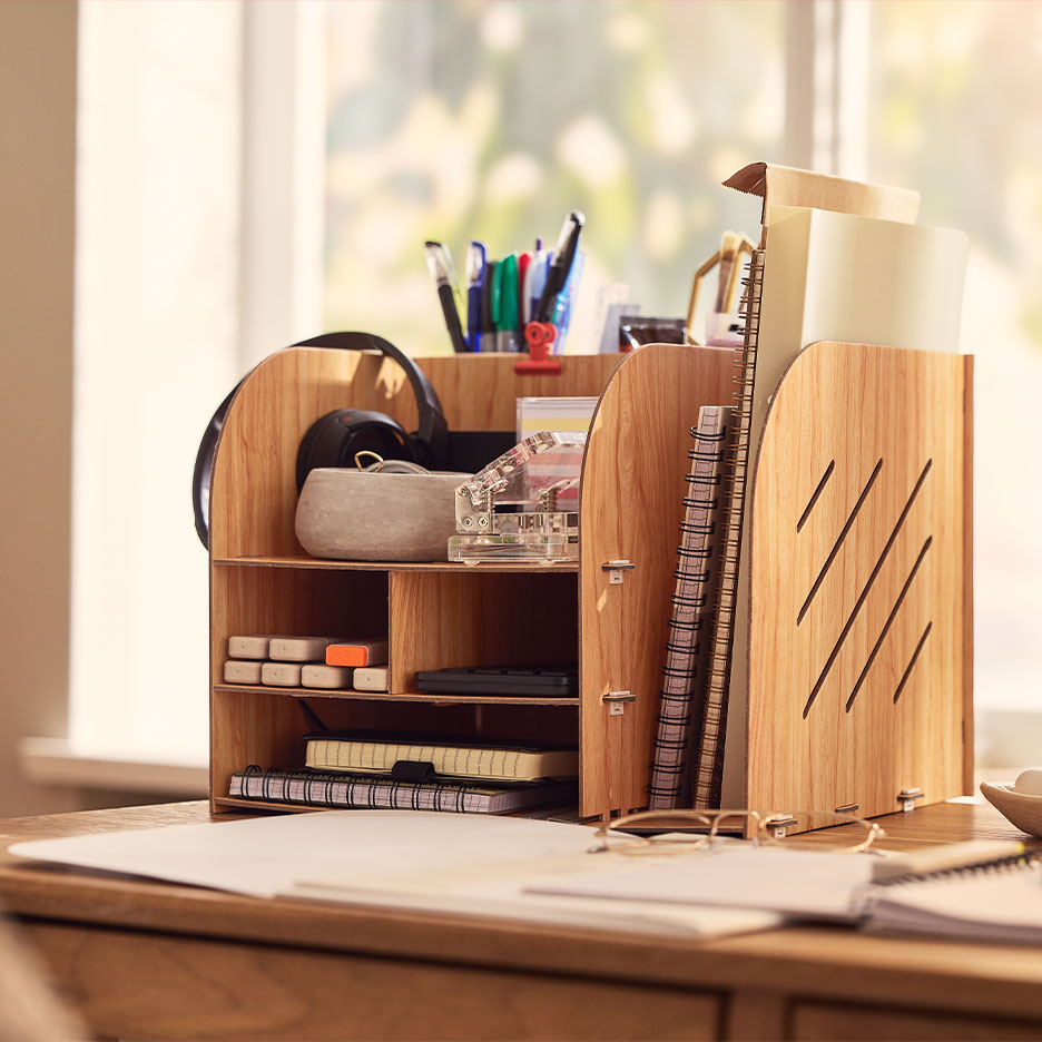 Wooden desk organizer with compartments for pens, notebooks, and office supplies.