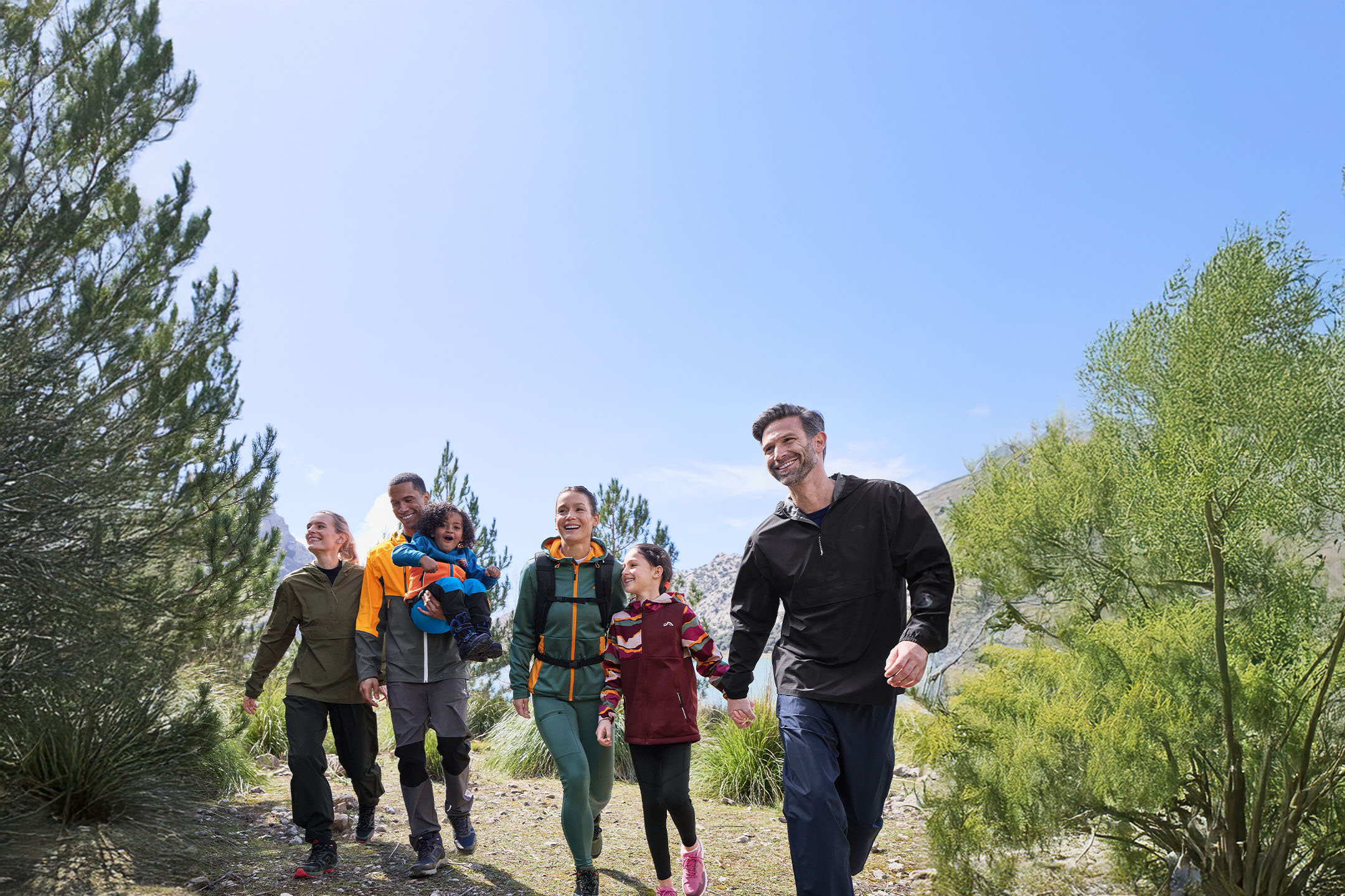 Family in Crivit sportswear hiking on a mountain trail.