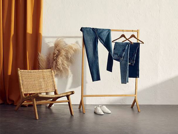 Jeans, rattan chair, wooden rack.