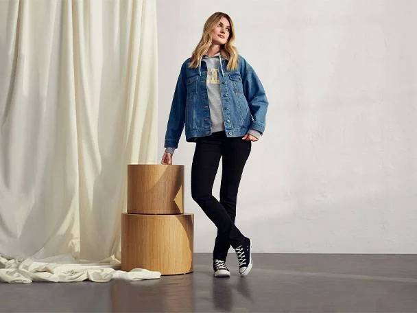 Denim jacket, jeans, and wooden tables.