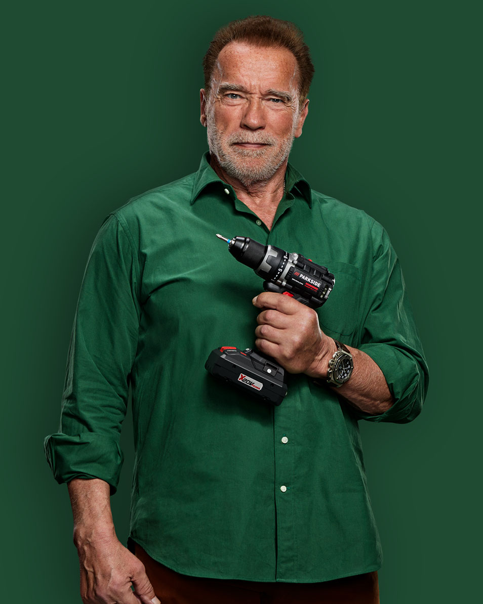 Arnold Schwarzenegger holding a Parkside drill.