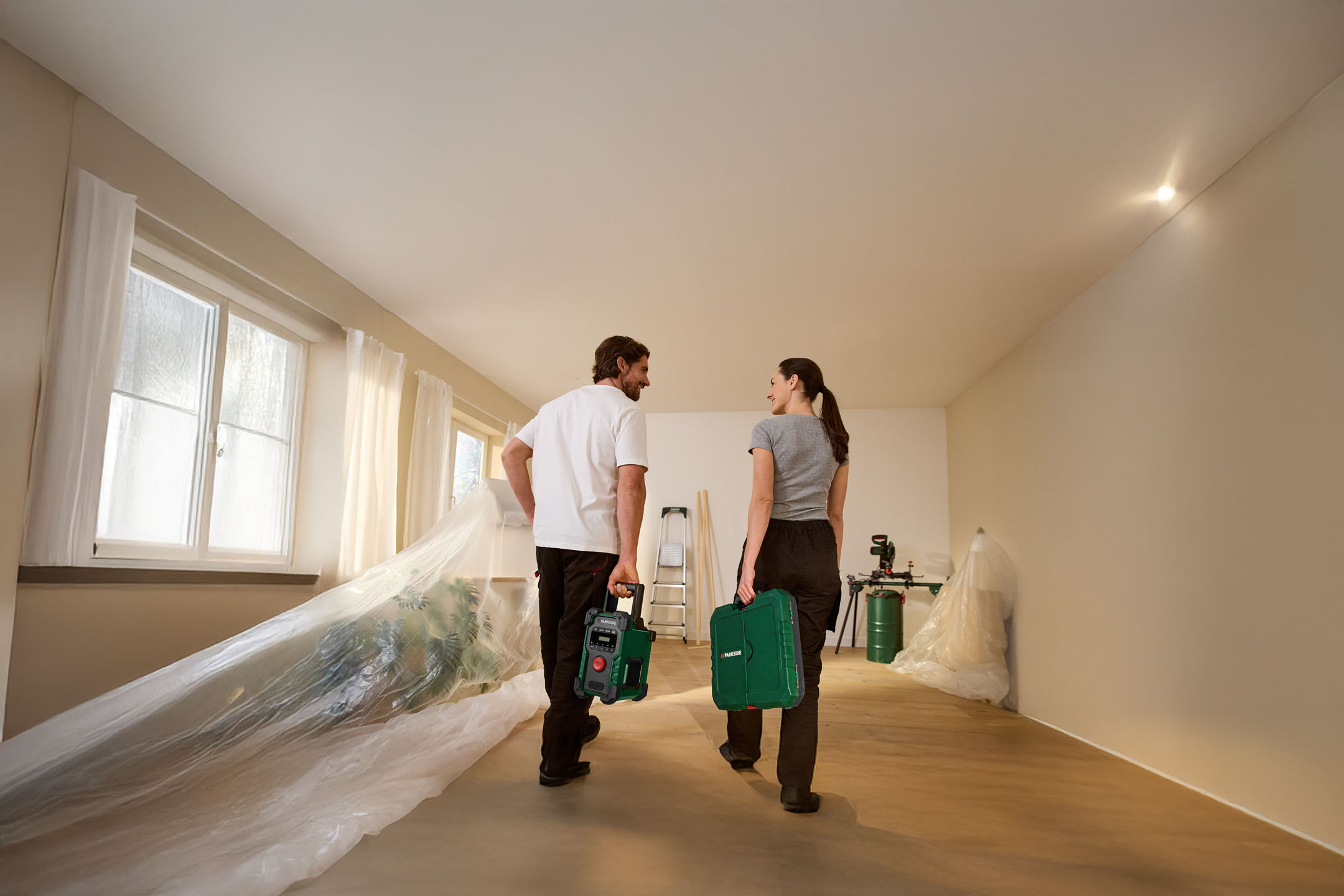 Couple with Parkside tools in a house under renovation.