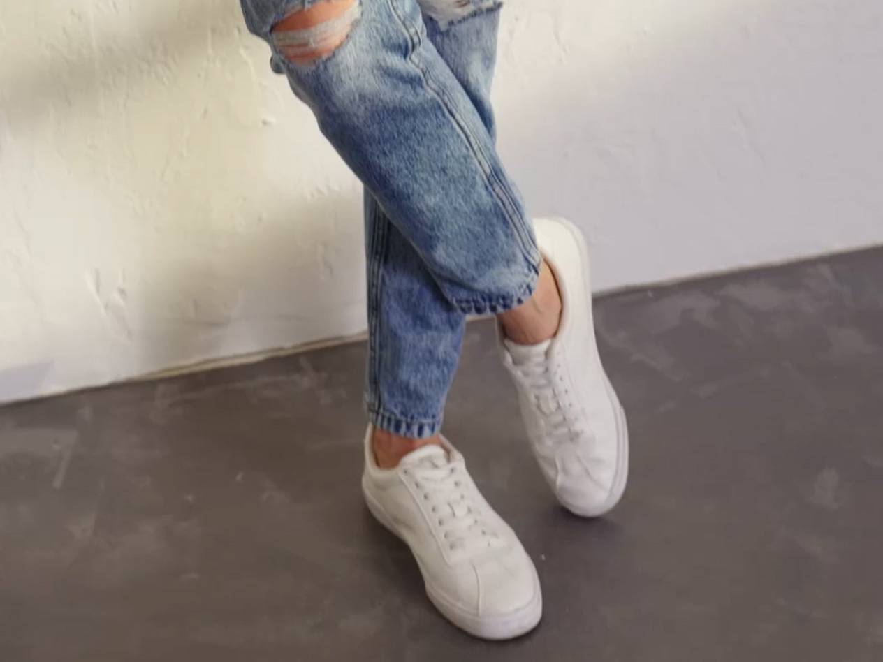 Jeans and white sneakers.